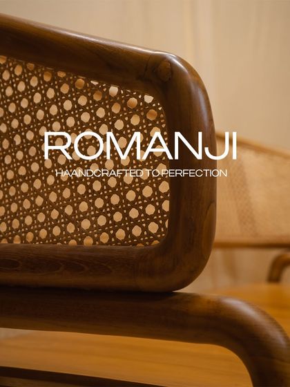 The 'Romanji' bench, handcrafted from premium teak wood. The rattan backrest and curved handrests offer unmatched comfort and style for any indoor space.