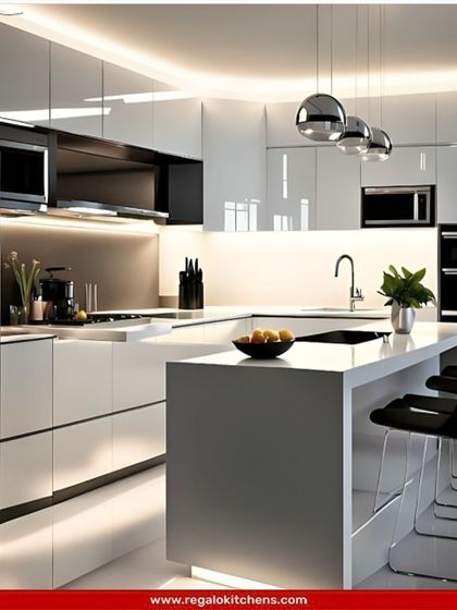 This ultra-modern kitchen features high-gloss white handle-less cabinets and a minimalist island with bar seating. The reflective surfaces and clean lines create a bright, spacious, and futuristic feel, perfect for a contemporary home.