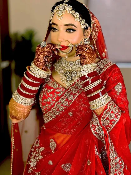 The final touches. Adjusting the nath is a crucial step. I ensure it's placed perfectly so it's comfortable for the bride and looks stunning in photos.
