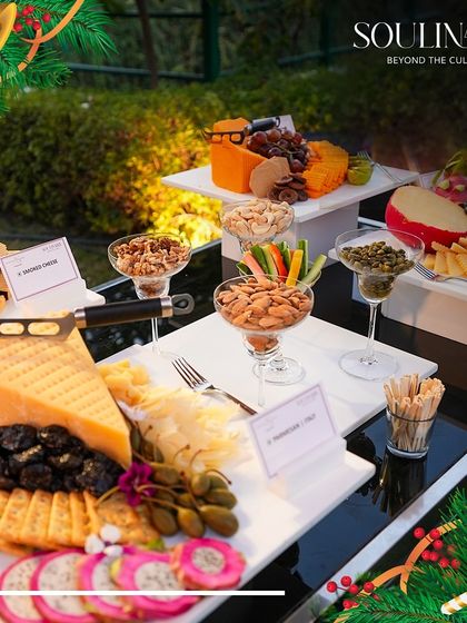 An elaborate cheese and charcuterie board, part of a festive Christmas spread. We offer a wide selection of artisanal cheeses, nuts, and fruits for holiday gatherings.