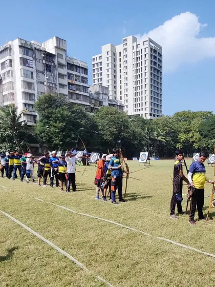 The shooting line at the SFA Archery Championship in Goregaon, with archers from different age groups participating.