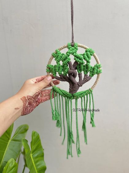 Here is my mini Tree of Life, held for scale. It's small enough to be a car charm or to hang in a cozy nook, but still has all the beautiful, handmade details.