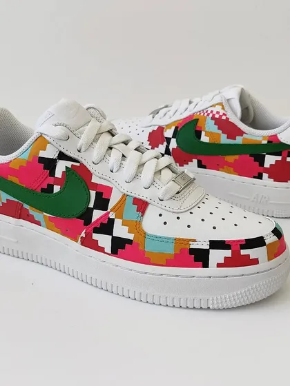 A full view of the Dhurrie weave inspired AF1s. The combination of pink, red, turquoise, and black creates a vibrant and modern look while honouring a traditional craft.