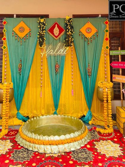 This view highlights the 'Haldi' neon sign and the intricate details of the traditional Rajasthani hangings used in the backdrop.