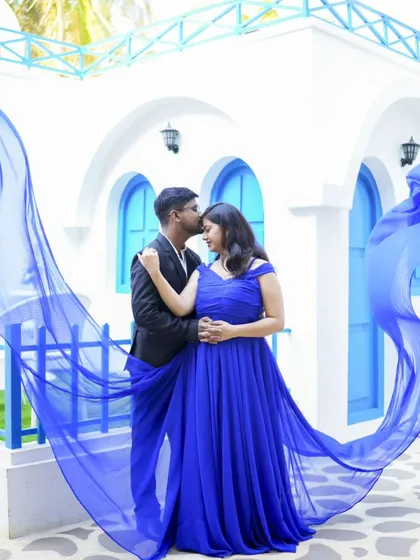 A dreamy and romantic shot with the bride's blue gown flowing in the wind. Our Santorini-themed location provides the perfect backdrop.