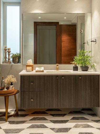 Luxury and relaxation meet in this well-appointed washroom. The floating vanity with dark wood grain contrasts beautifully with the bold, geometric-patterned floor, creating a spa-like escape.