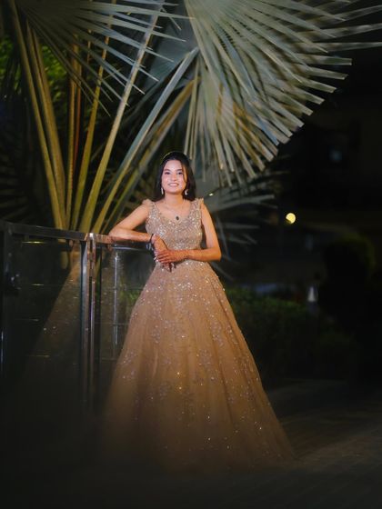 A beautiful outdoor shot of the engagement bride, her gown sparkling in the evening light.
