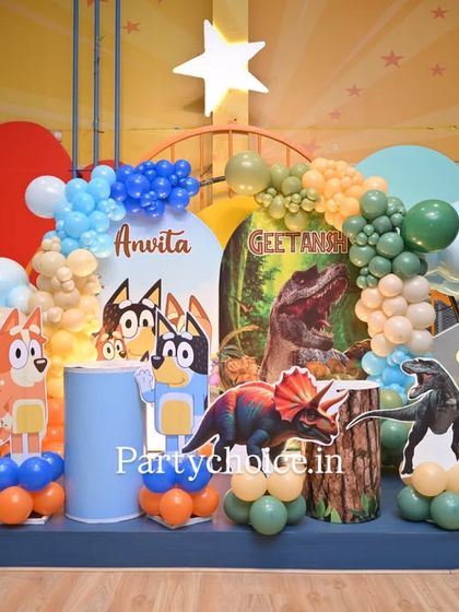 A unique combined theme featuring Bluey and Dinosaurs. This colorful setup includes character cutouts from both worlds, cloud-shaped balloon clusters, and a personalized backdrop for a one-of-a-kind party.