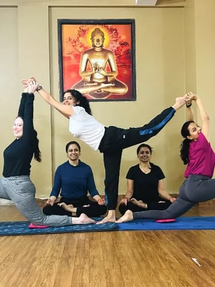 A beautiful partner yoga formation in our studio. Acro yoga teaches trust, balance, and communication between partners.