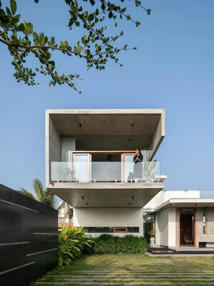 A detail of the cantilevered bedroom, where a resident enjoys the view from the balcony. This image highlights how our designs create private, elevated spaces that connect inhabitants with the outdoors.
