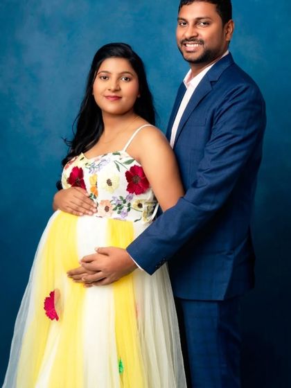 A classic couple's portrait, with the mom-to-be glowing in our yellow and white floral gown.