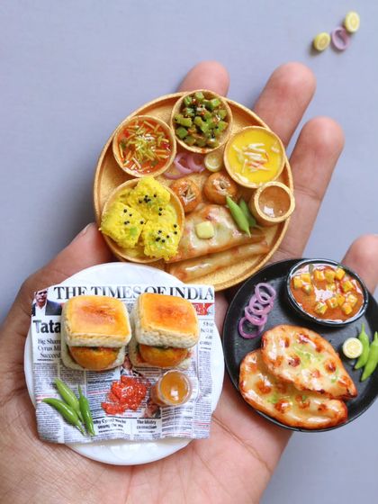 A collection of my North Indian miniatures, including vada pav, a Kathiawadi thali, and naan with channa.