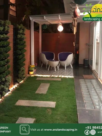 The right lighting transforms a garden into a 24/7 usable space. This night view of our courtyard project highlights the ambient lighting we installed along the vertical garden base, creating a warm and inviting atmosphere for evening relaxation.