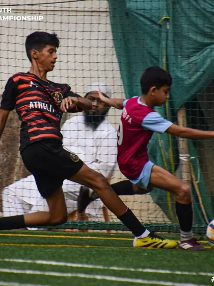 A clash of champions. Two players challenge for the ball in a high-stakes game.