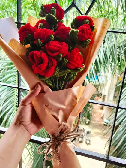 A full bouquet of classic red crochet roses, wrapped simply in brown paper and tied with twine. It’s a timeless, romantic gesture that will last a lifetime.