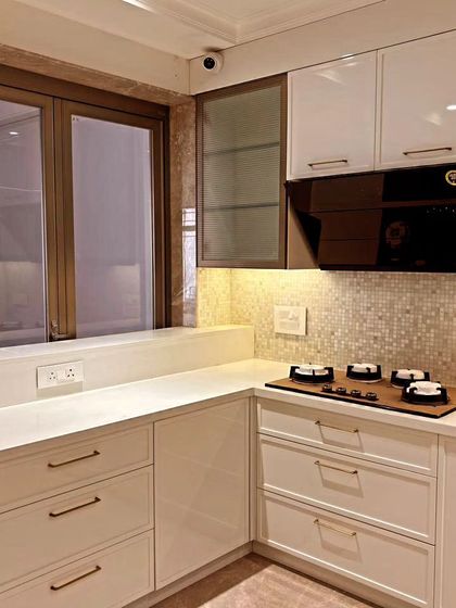A corner view of the kitchen, demonstrating how the design wraps around the space to maximize counter area and storage. The under-cabinet lighting provides excellent task illumination.