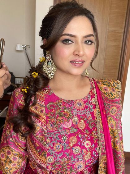 A final portrait of this stunning bride. The makeup is bold yet balanced, capturing the joyful spirit of the event.