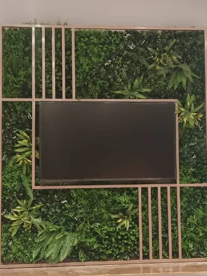 For the Biba showroom, we designed and installed this custom artificial green wall that frames a media screen, blending technology with nature for a unique and engaging retail environment.