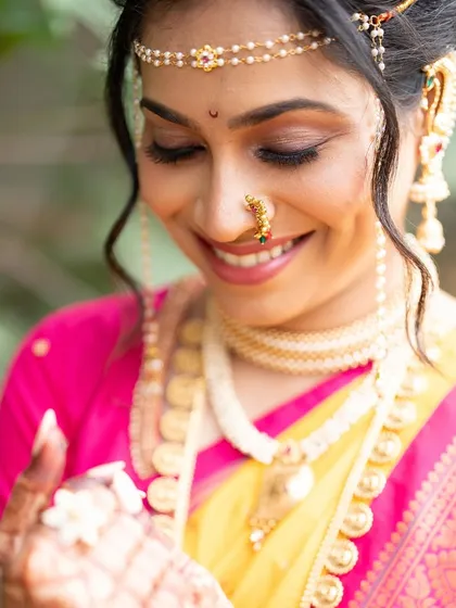 The happiness of a bride is the most beautiful thing. The makeup here is all about enhancing her natural glow, with a focus on skin-like texture and soft, warm tones.