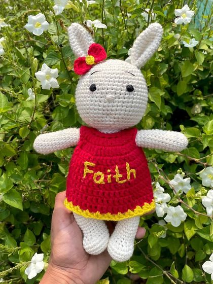 This bunny in a bright red and yellow dress is personalized with the name "Faith". The vibrant colors make her so cheerful and fun.