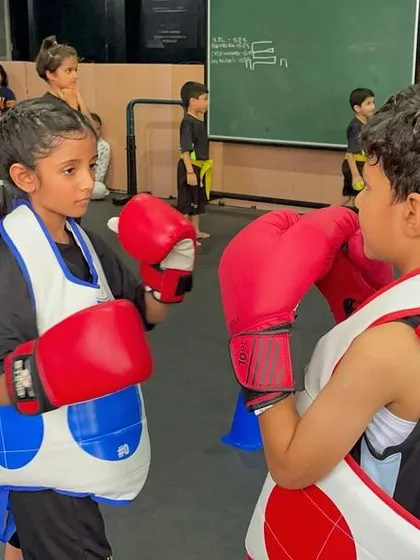 Martial arts is a journey of growth and self-discovery. Two young students face each other with respect before a sparring drill begins.