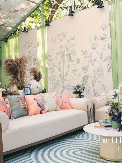 A wide view of 'The Conservatory' lounge, showcasing the custom flooring and botanical wallpaper.
