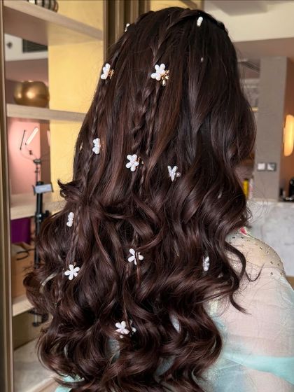 A side view of the whimsical multi-braid hairstyle.