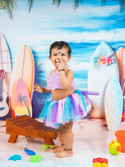 Making a splash with her adorable smile. The beach theme is great for capturing high-energy, playful moments.