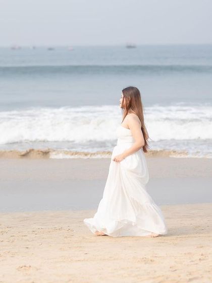 A candid walking shot on the beach, capturing the couple in a natural and happy moment during their Goa pre-wedding session.