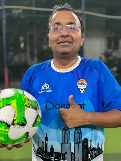 Another member of our diverse community, holding a ball and ready to play. Our program brings together people from all walks of life.
