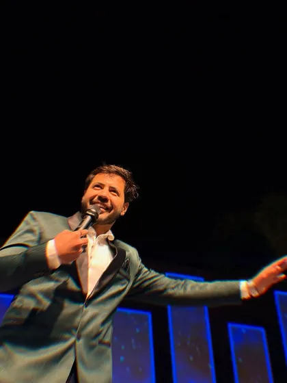 Reaching out to the audience, inviting them to join the fun. My hosting style is all about interaction and engagement.