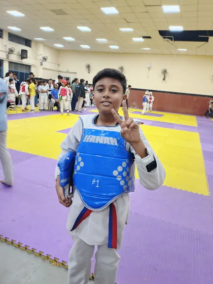 A young student in his blue chest guard, ready for his match at the Delhi state school Taekwondo championship.