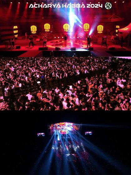 Capturing the peak energy at Acharya Habba 2024 with a wide shot of the massive crowd and a high-angle view of the stage lights piercing the night sky. This type of aerial event coverage is perfect for promotional videos.