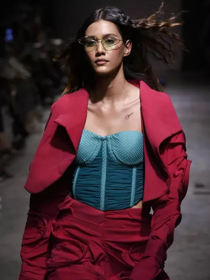 A vibrant and edgy look for a FAD International runway show. The makeup features a pop of color and unique styling to complement the avant-garde student collection.