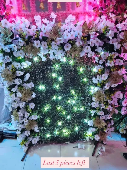 A beautiful ready-made backdrop option, this piece features a green wall with white and gold flowers, and integrated lights for an instant festive glow.