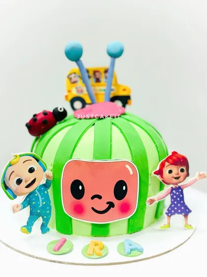 A cute Cocomelon cake shaped like the iconic watermelon logo. This is a fun, sculpted design that's instantly recognizable.