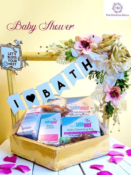 A simple yet elegant baby shower hamper. This wooden basket is filled with premium Sebamed baby bath products and adorned with a floral arrangement.