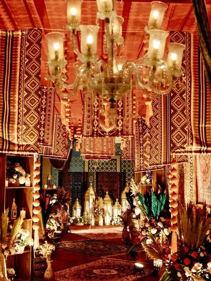 A view down the vintage bazaar entrance, with layers of rugs, warm lighting, and floral details creating a sense of depth and opulence.