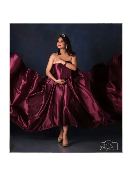 A solo portrait showcasing the magnificent flowing fabric of the satin gown. The mama-to-be looks like a true diva.