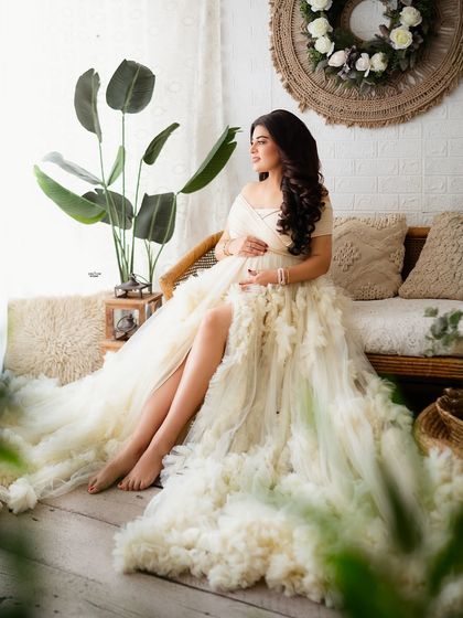 A serene moment on our rattan sofa. The greenery and natural textures create a peaceful and beautiful setting for this mamma-to-be.