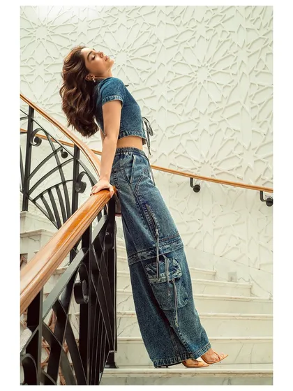 Sharvari captured in a moment of effortless style. The clean lines of the architecture and the natural light complement her relaxed yet chic denim look.