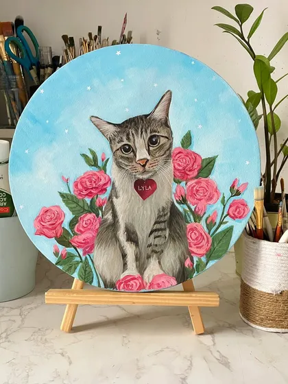 A portrait of Lyla, a sweet cat, surrounded by her favorite roses. I can incorporate floral elements or other meaningful details into the background to make the piece even more special.