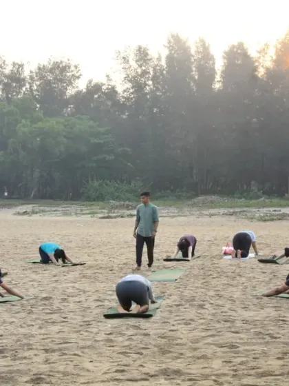 I believe in guiding with presence and attention. Here I am observing the group in Child's Pose, ensuring everyone feels supported as they connect with their breath at sunrise.