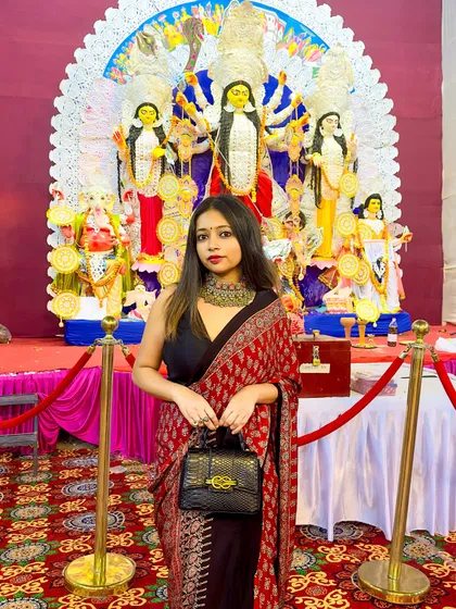 My Saptami look for Durga Puja. I styled this beautiful Ajrakh print modal silk saree with a simple black blouse and a statement necklace for a modern ethnic look.