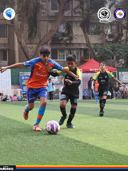 Dribbling through traffic. This player showcases the close control and agility we develop in our athletes.