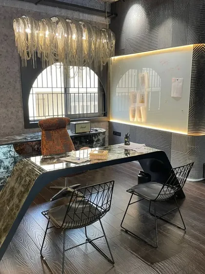 Our commercial designs are tailored to the brand's story. For this fashion and dance studio, we crafted a glamorous and inspiring workspace with bold materials, custom furniture, and dramatic lighting to foster creativity and make a lasting impression.