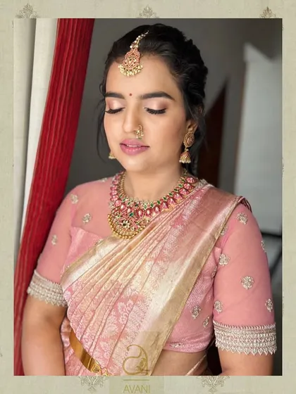 A soft pink saree paired with a matching sheer-sleeve blouse. The delicate embroidery on the sleeves adds a touch of sparkle to this understated and elegant ensemble.