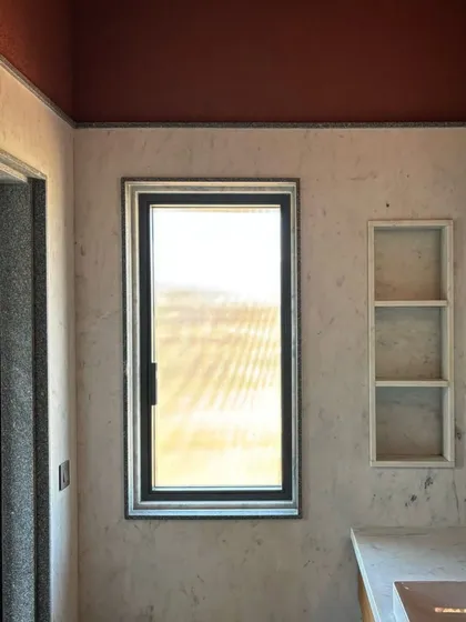 A preview of an interior featuring colors developed in collaboration with artist Malene Bach. The subtle textures and carefully chosen hues of the walls and ceiling create a serene and sophisticated atmosphere.
