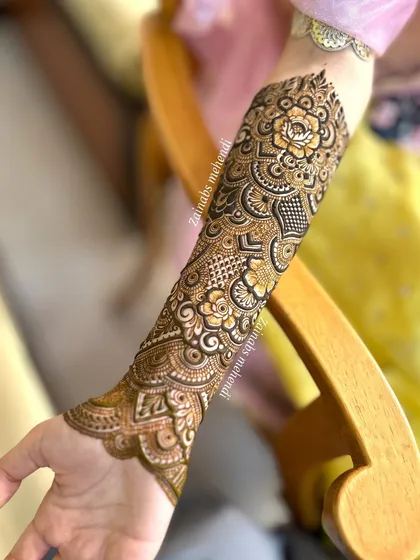 A beautiful shot of Momina's full arm henna, showcasing the intricate details and the flow of the design.