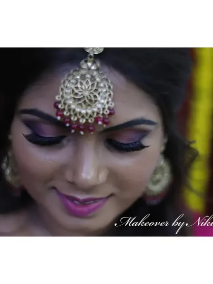 A close-up of Namratha's minimal and natural mehendi makeup. The focus is on a dramatic purple smokey eye and a matching lip color.